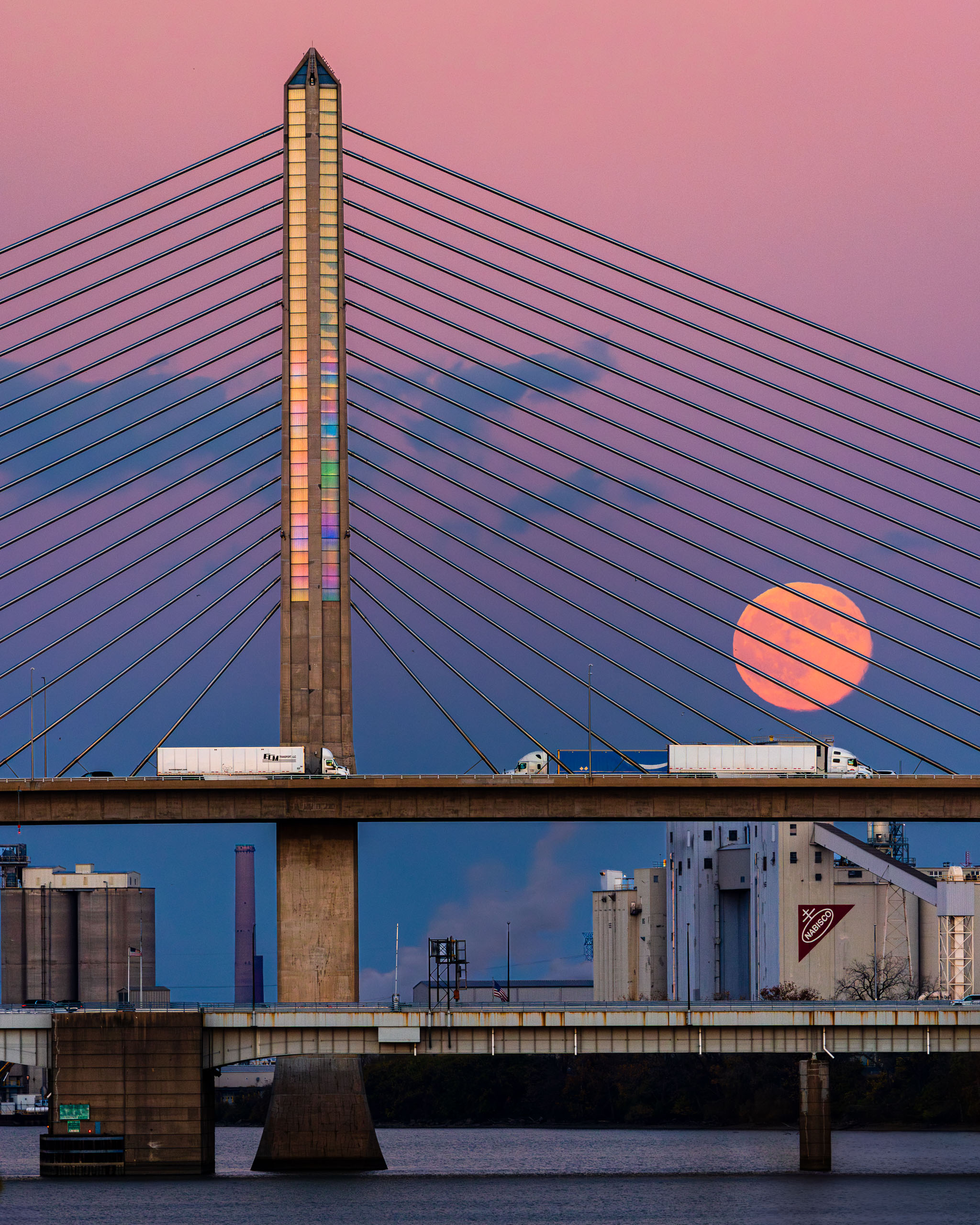 The moon rises, as a full supermoon, above the Veterans Memorial Bridge over the Maumee River in downtown Toledo, Ohio.